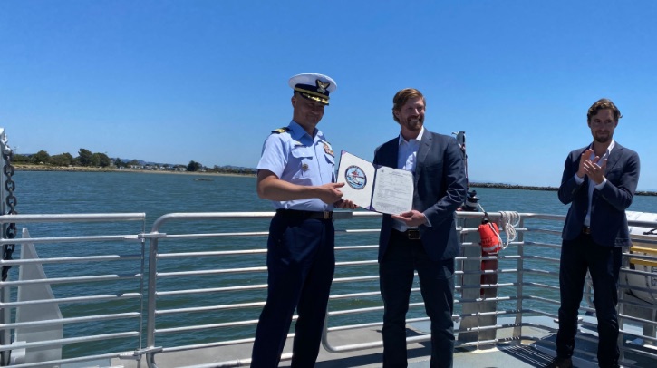 Captain Taylor Q. Lam presents Pace Ralli, CEO of Switch Maritime, with signed Certificate of Inspection.