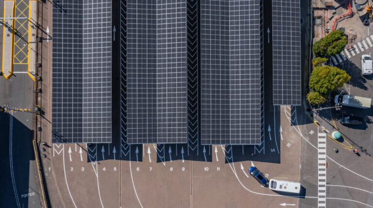Portsmouth International Port slashes electricity costs with solar technology Aerial show of Portsmouth International Port and the solar panels that have been installed, with the sun shining