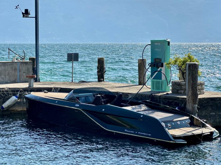Aqua Superpower installs marine fast charger at Lake Garda The new Aqua Superpower marine fast charger installed at Lake Garda, on a small wooden jetty on green-blue water and under a blue sky