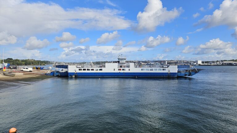 A photo of the Torpoint Ferry service in operation with a blue sky and scattered cloud above