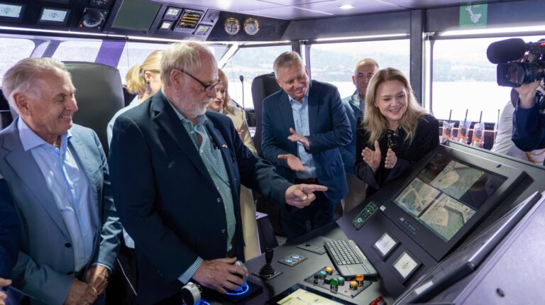 World’s largest battery-electric ship completes first propulsion trial Company representatives of Incat Tasmania stand on the bridge of the world’s largest battery-electric ship, Hull 096.